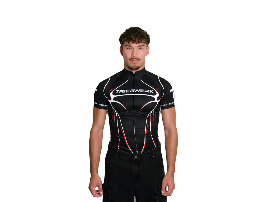 Person wearing a black cycling jersey with 'Trieswerk' branding on a white background