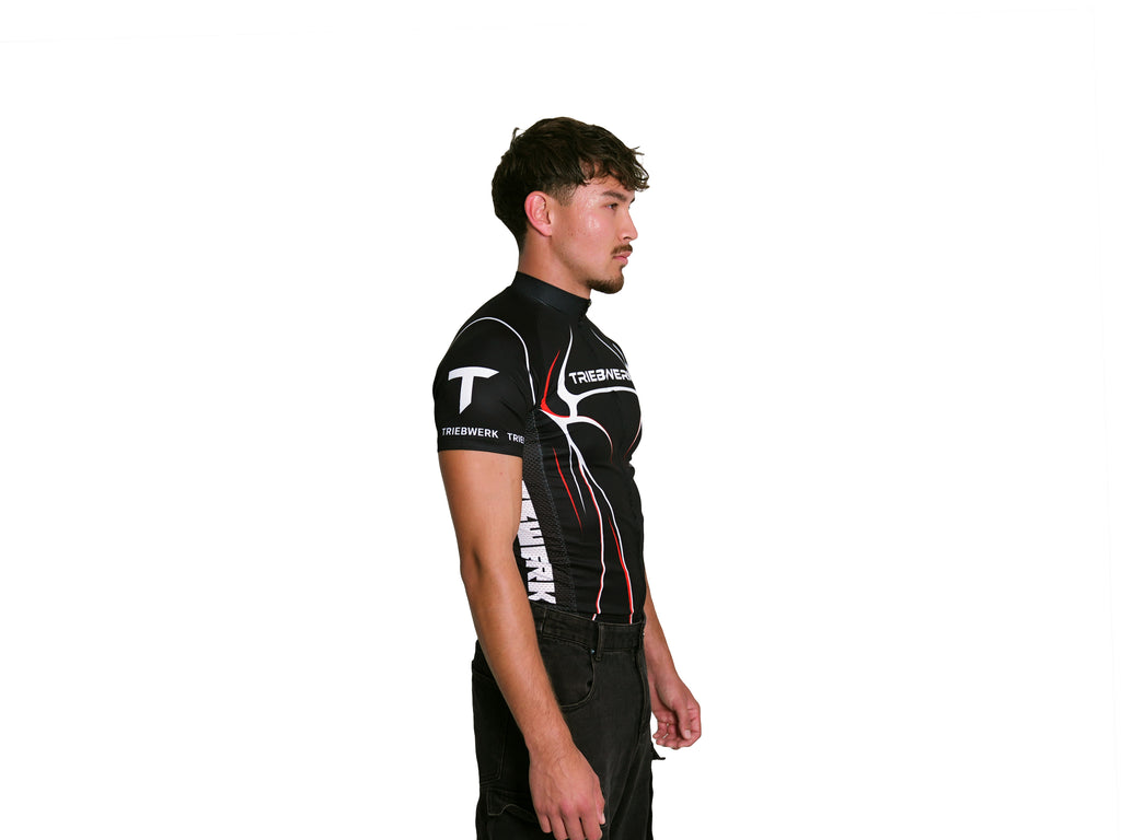 Person wearing a black and red sports outfit with visible branding on a white background