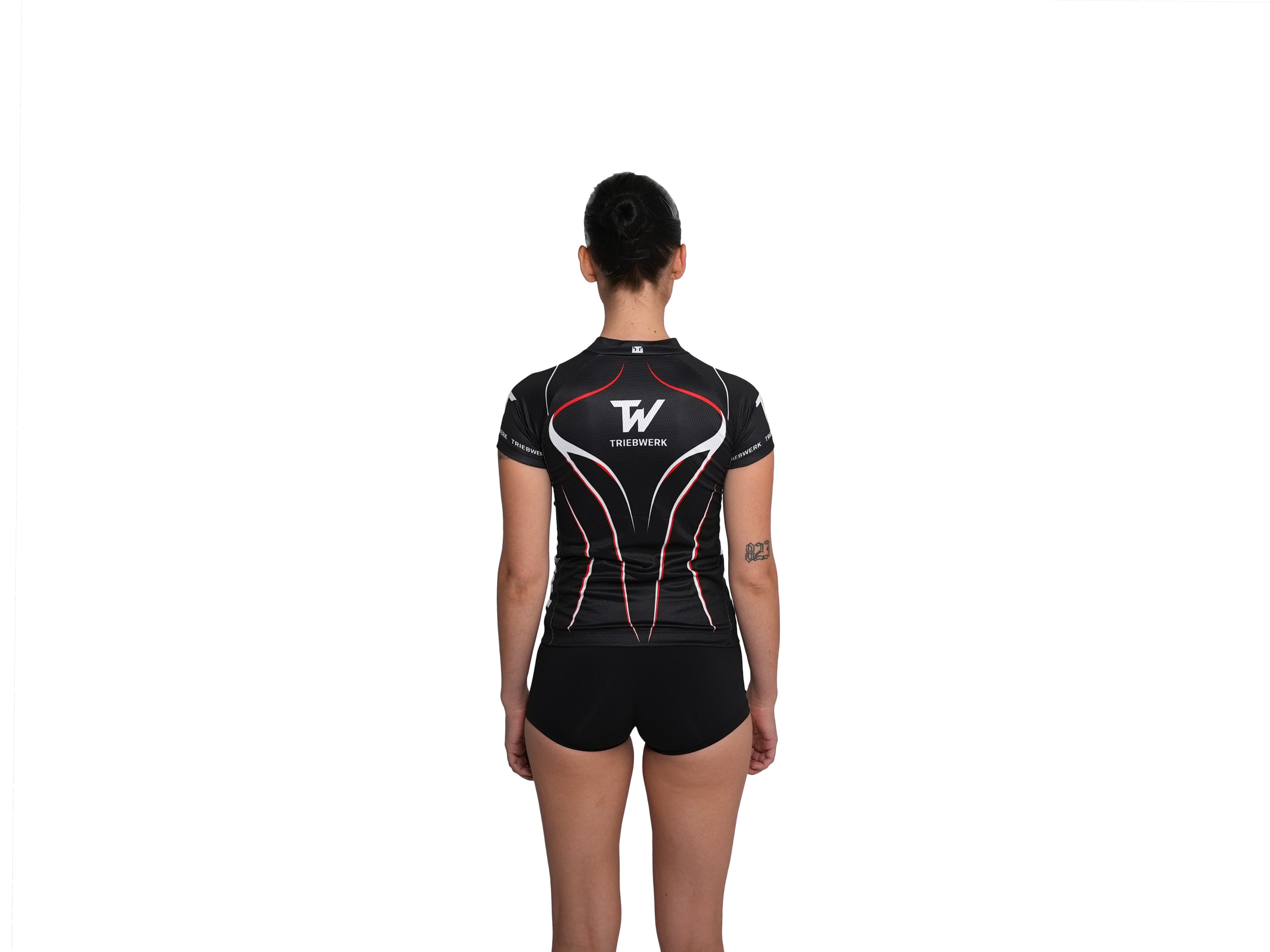Person wearing a black athletic outfit with a logo on the back against a white background