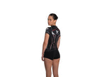 Woman wearing a black athletic outfit with a logo on a white background